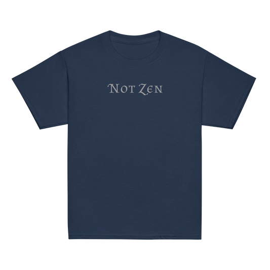 "Not zen" printed on a navy youth classic tee laying on a flat surface