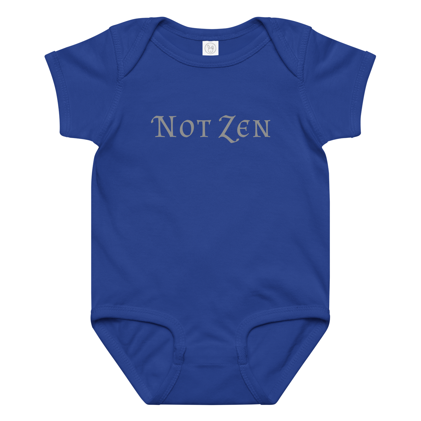 "Not zen" printed on a royal baby jersey bodysuit laying on a flat surface amongst other clothes