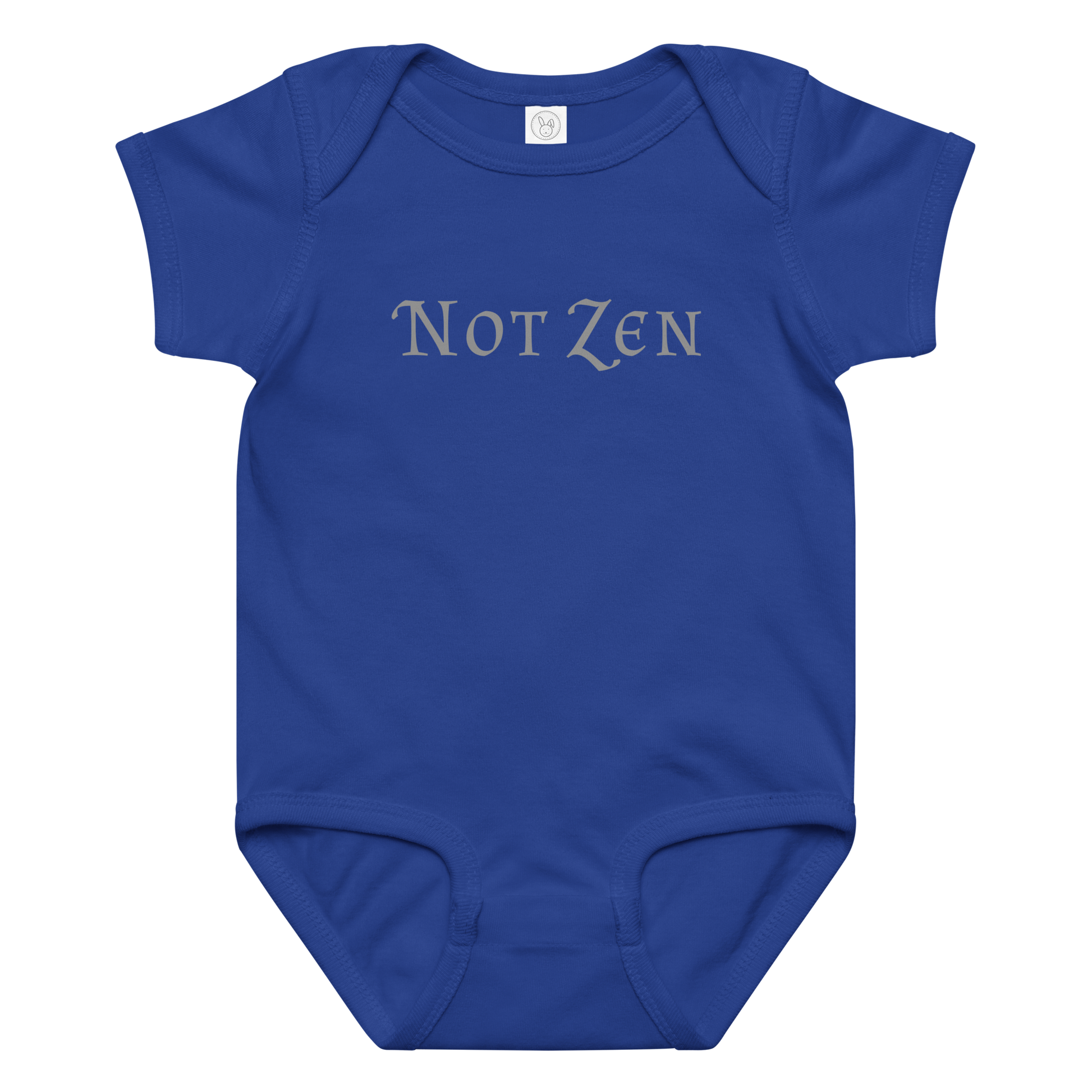 "Not zen" printed on a royal baby jersey bodysuit laying on a flat surface amongst other clothes