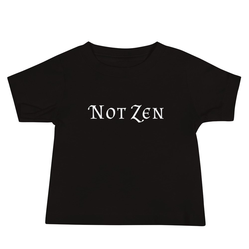 "Not zen" printed on a black baby jersey short sleeve tee laying on a flat surface