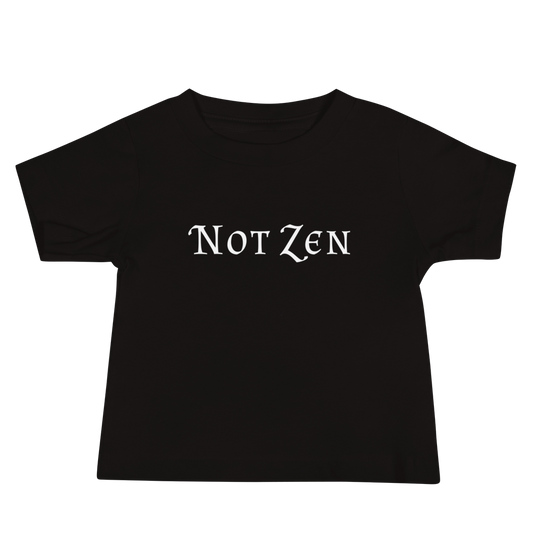 "Not zen" printed on a black baby jersey short sleeve tee laying on a flat surface