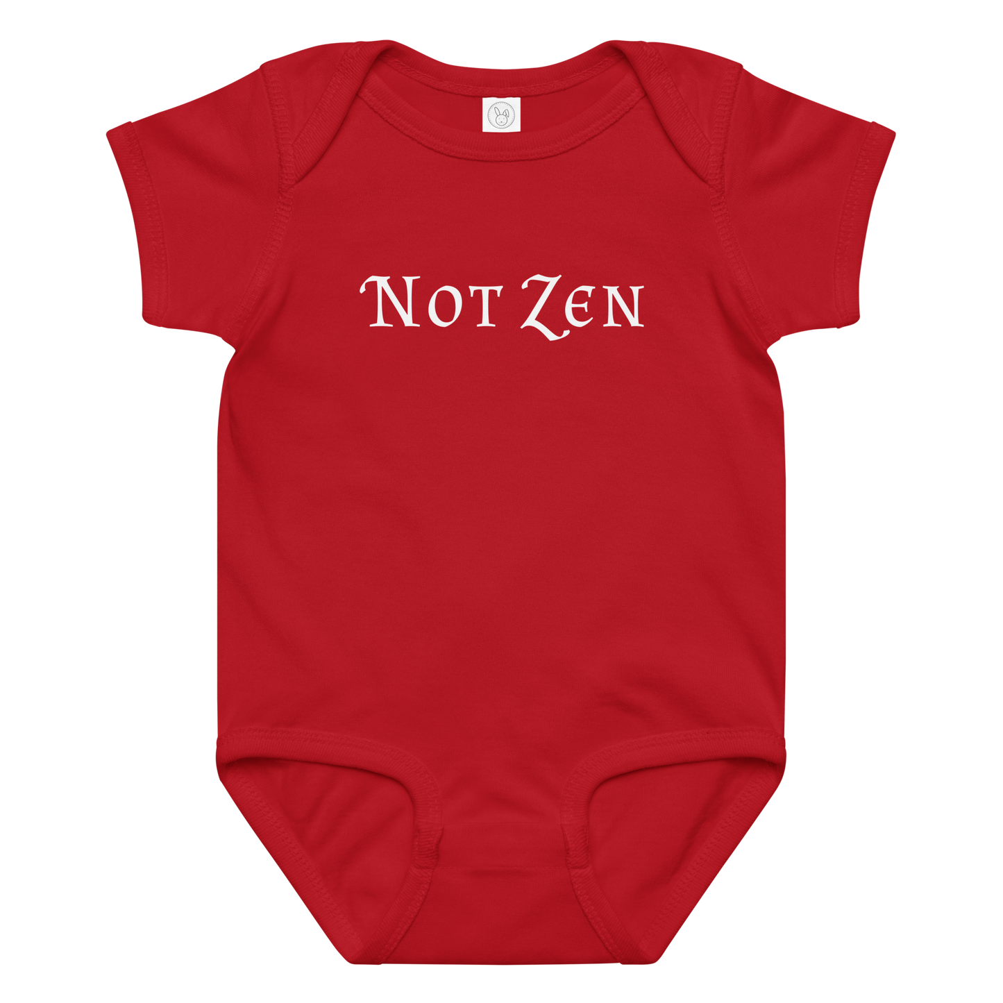 "Not zen" printed on a red baby jersey bodysuit laying on a flat surface amongst other clothes