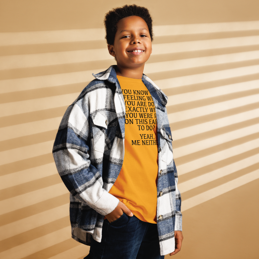"You know that feeling when you are doing exactly what you were put on this earth to do? Yeah, Me Neither" printed on a gold youth classic tee worn by a male also wearing a jacket