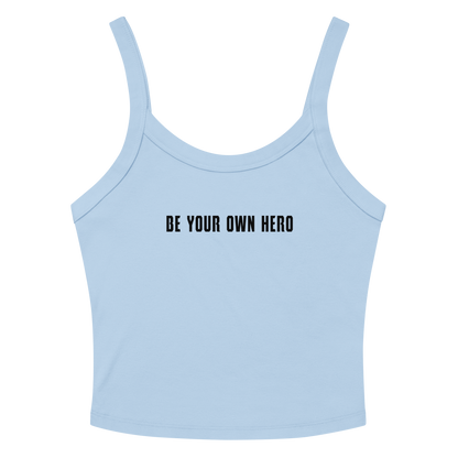 "Be your own here" printed on a solid baby blue blend women's micro-rib tanktop laying on a flat surface amongst sunglasses and shorts