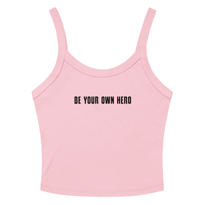"Be your own here" printed on a solid pink blend women's micro-rib tanktop laying on a flat surface amongst sunglasses and shorts