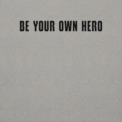 "Be your own here" printed on a carbon grey background