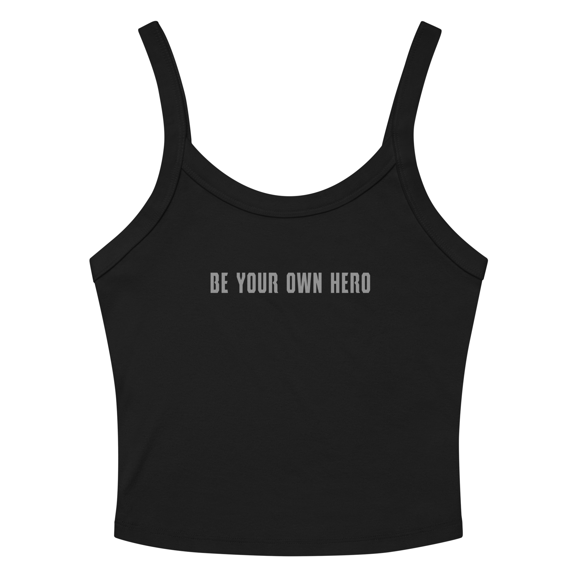 "Be your own here" printed on a solid black blend women's micro-rib tanktop laying on a flat surface amongst sunglasses and shorts