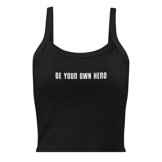 "Be your own here" printed on a solid black blend women's micro-rib tanktop laying on a flat surface
