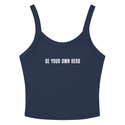 "Be your own here" printed on a solid navy blend women's micro-rib tanktop laying on a flat surface amongst sunglasses and shorts