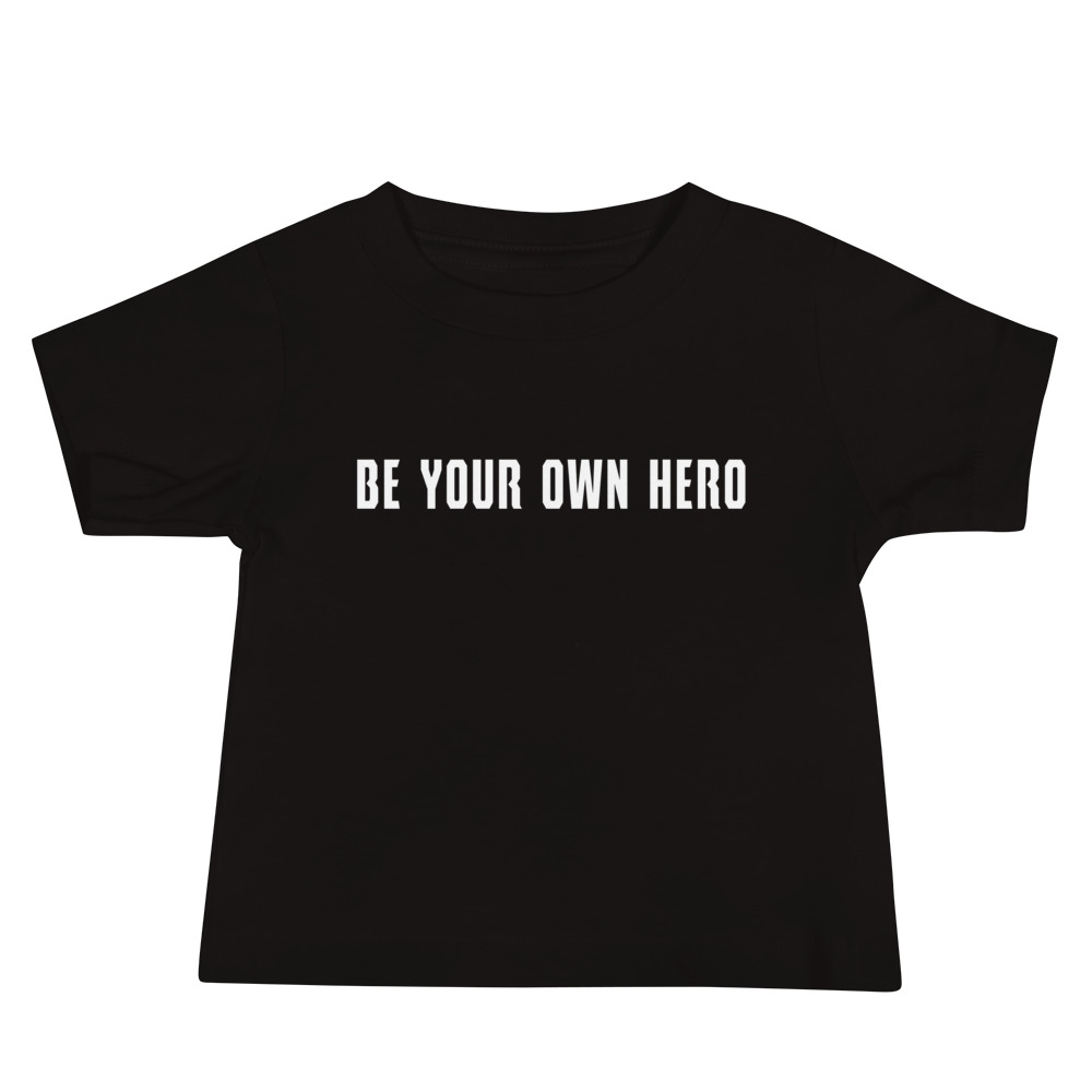 "Be your own here" printed on a black baby jersey short sleeve tee laying on a flat surface