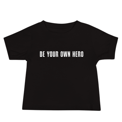 "Be your own here" printed on a black baby jersey short sleeve tee laying on a flat surface