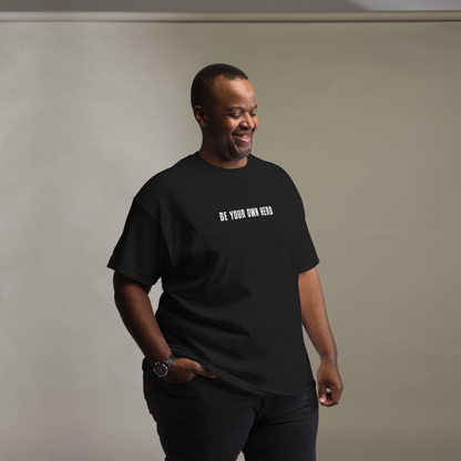 "Be your own here" printed on a black unisex classic tee worn by a male