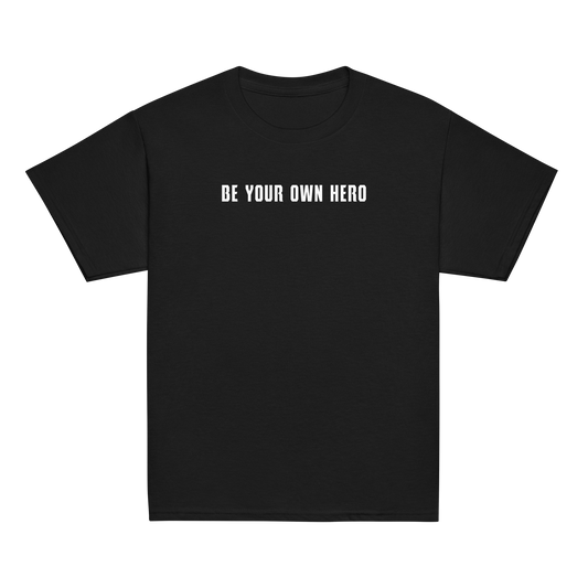 "Be your own here" printed on a black youth classic tee laying on a flat surface