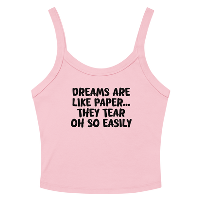 "Dreams are like paper, they tear oh so easily" printed on a solid pink blend women's micro-rib tanktop laying on a flat surface amongst sunglasses and shorts