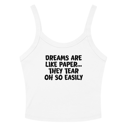 "Dreams are like paper, they tear oh so easily" printed on a solid white blend women's micro-rib tanktop laying on a flat surface amongst sunglasses and shorts