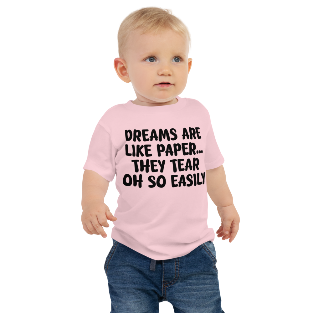 "Dreams are like paper, they tear oh so easily" printed on a pink baby jersey short sleeve tee worn by a male