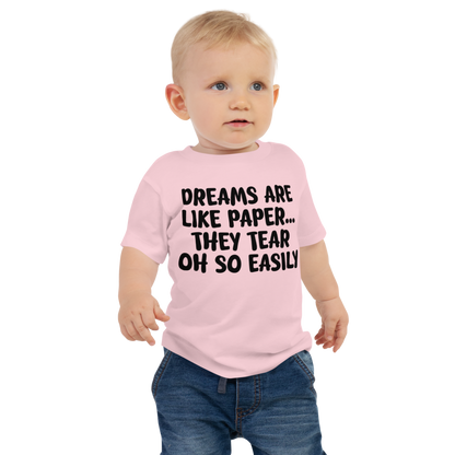 "Dreams are like paper, they tear oh so easily" printed on a pink baby jersey short sleeve tee worn by a male