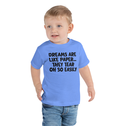 "Dreams are like paper, they tear oh so easily" printed on a heather columbia blue toddler short sleeve tee worn by a male