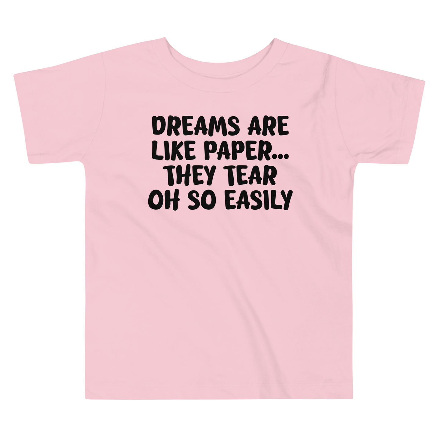 "Dreams are like paper, they tear oh so easily" printed on a pink toddler short sleeve tee laying on a flat surface