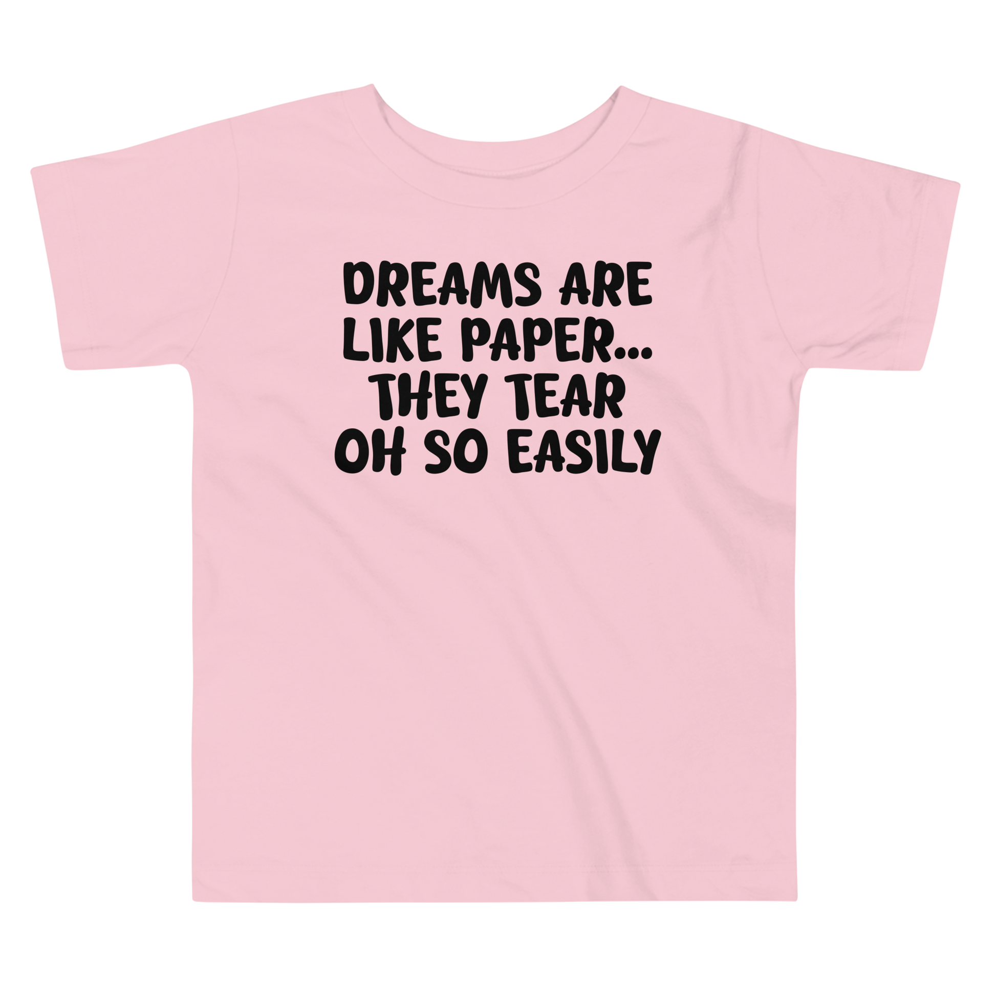 "Dreams are like paper, they tear oh so easily" printed on a pink toddler short sleeve tee laying on a flat surface