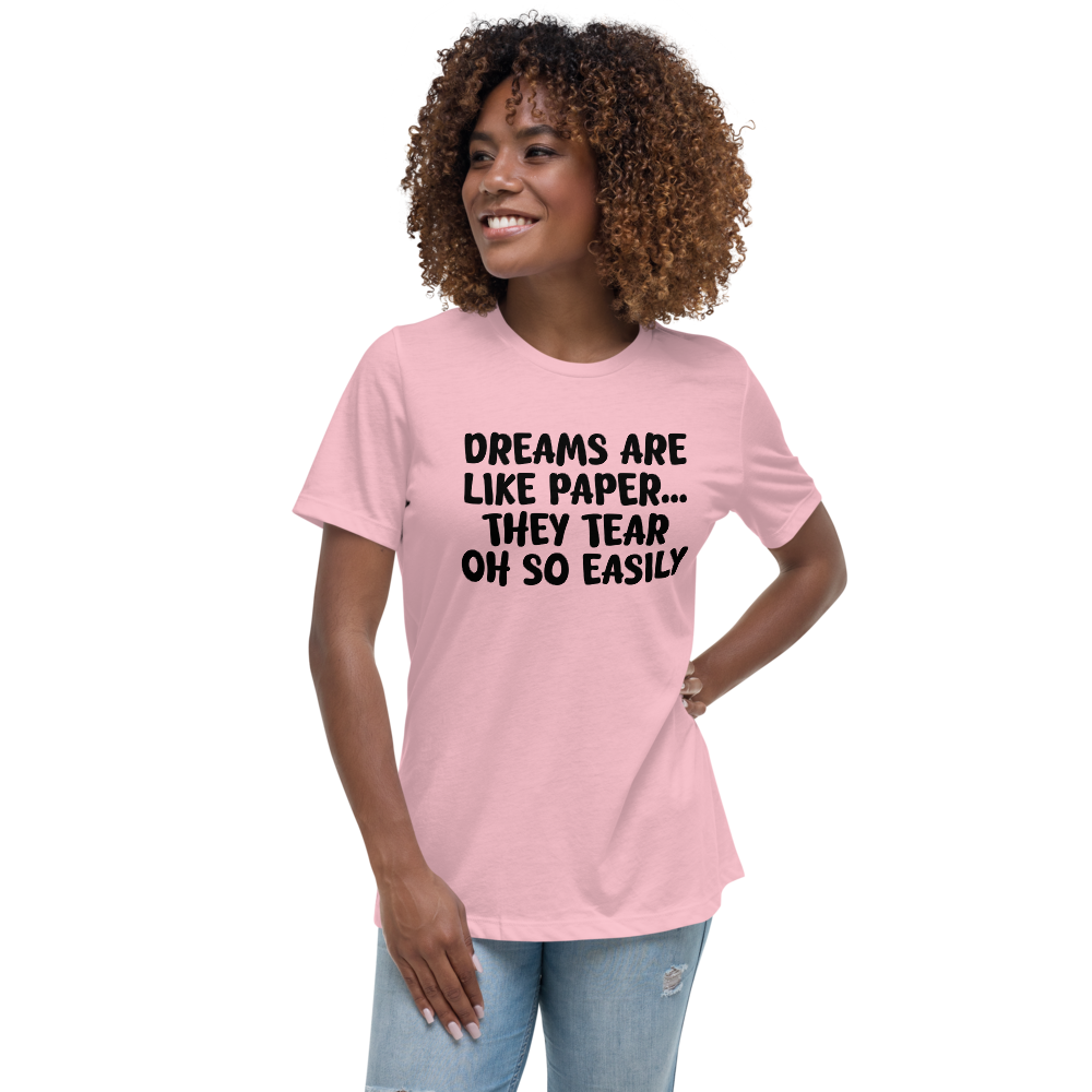 "Dreams are like paper, they tear oh so easily" printed on a pink women's relaxed t-shirt worn by a female