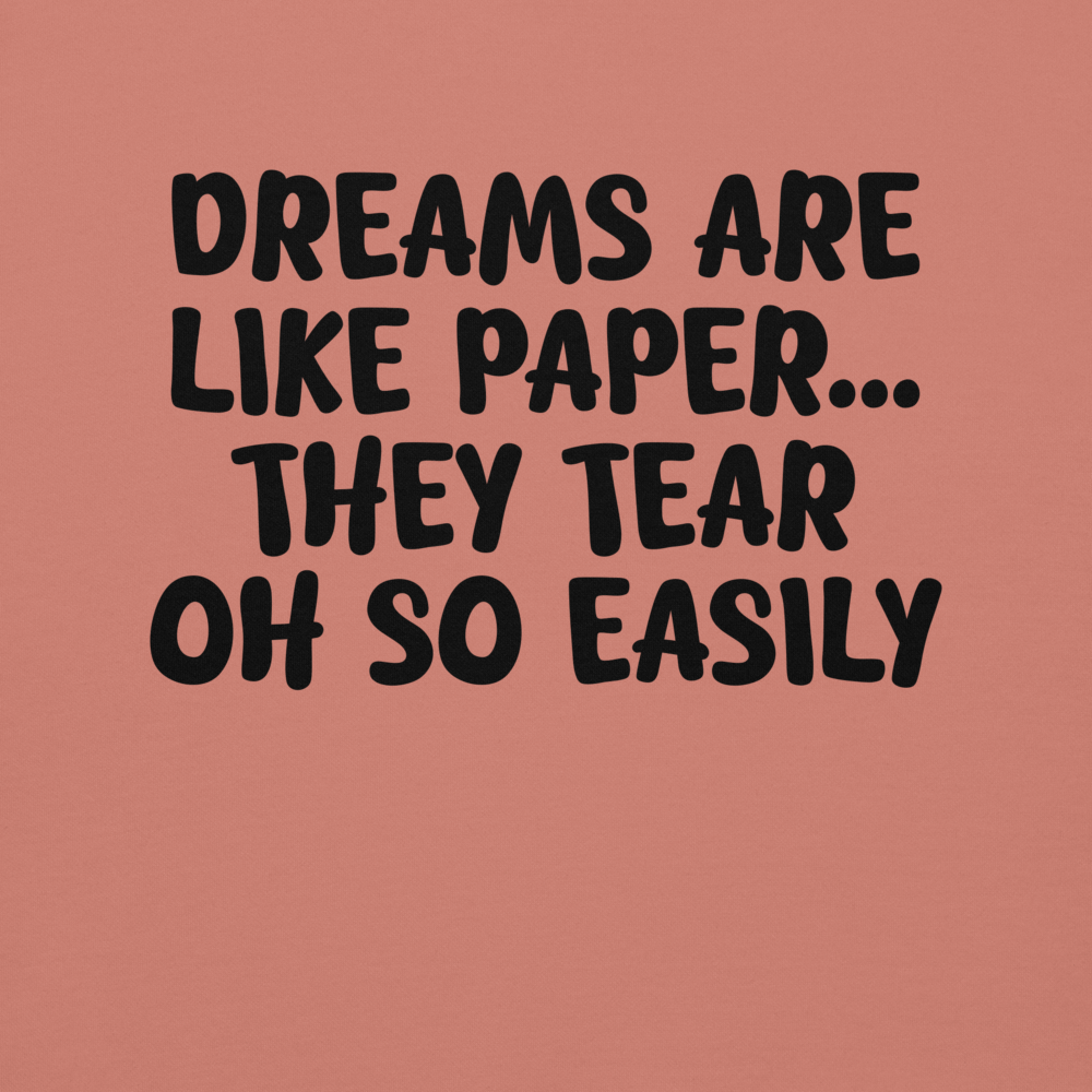 "Dreams are like paper, they tear oh so easily" printed on a dusty rose background