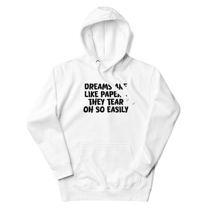 "Dreams are like paper, they tear oh so easily" printed on a white unisex hoodie laying on a flat surface with the hood up
