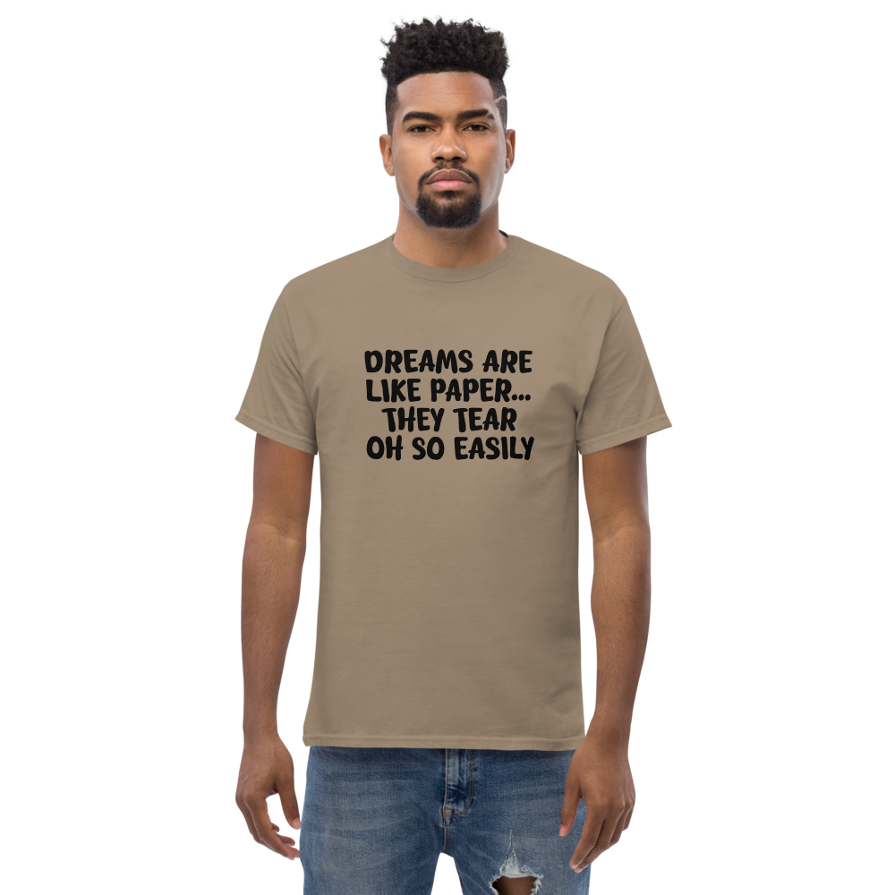 "Dreams are like paper, they tear oh so easily" printed on a brown savana unisex classic tee worn by a male