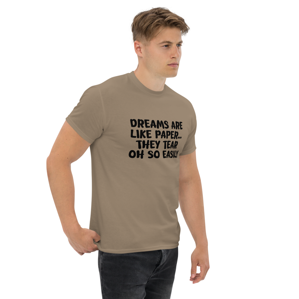 "Dreams are like paper, they tear oh so easily" printed on a brown savana unisex classic tee worn by a male