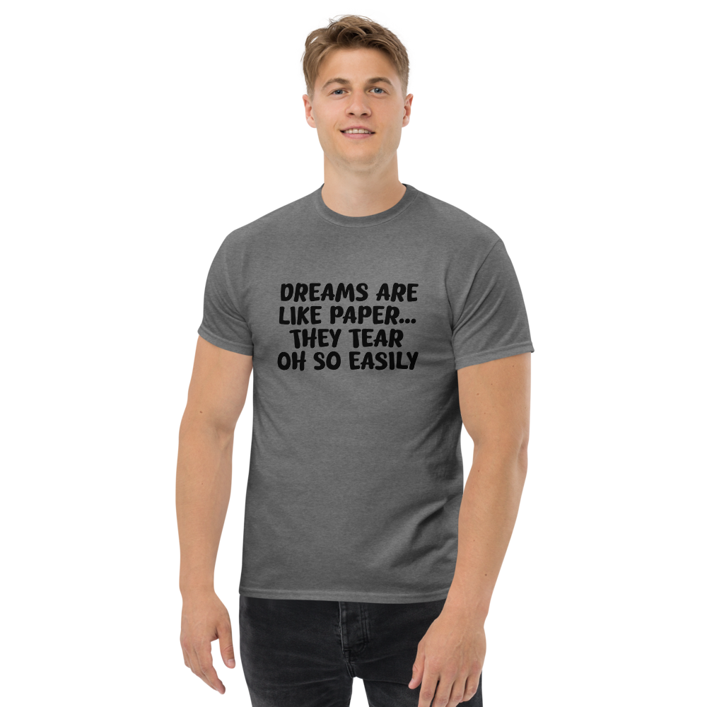 "Dreams are like paper, they tear oh so easily" printed on a graphite heather unisex classic tee worn by a male