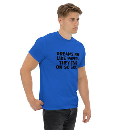 "Dreams are like paper, they tear oh so easily" printed on a royal unisex classic tee worn by a male
