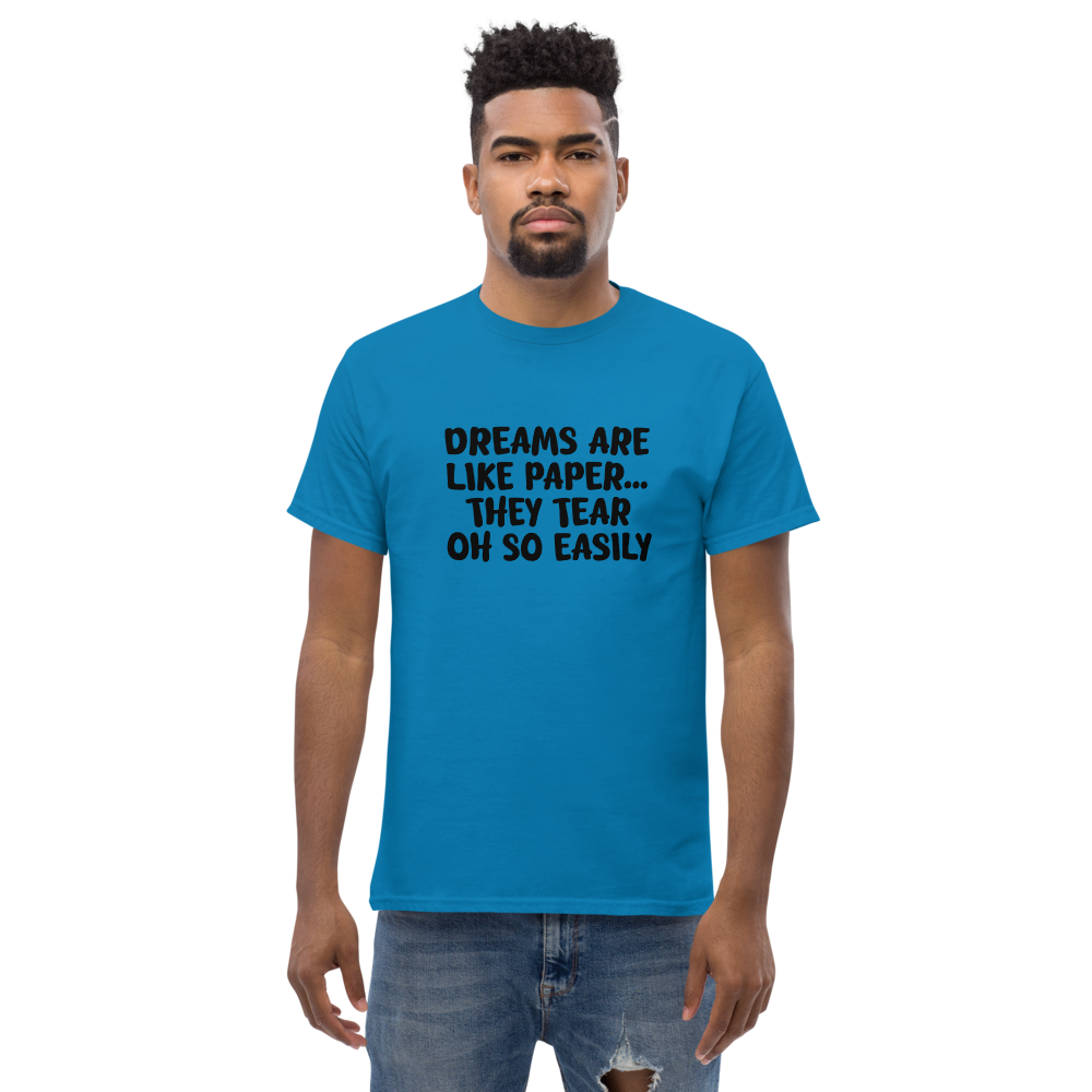 "Dreams are like paper, they tear oh so easily" printed on a sapphire unisex classic tee worn by a male