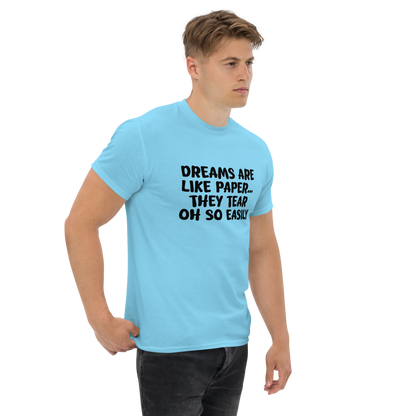 "Dreams are like paper, they tear oh so easily" printed on a sky unisex classic tee worn by a male