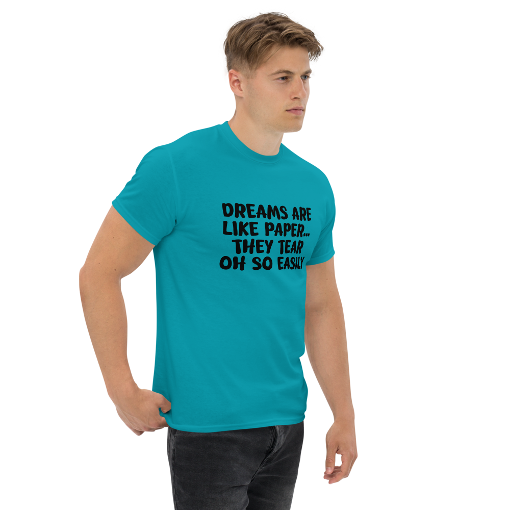 "Dreams are like paper, they tear oh so easily" printed on a tropical blue unisex classic tee worn by a male