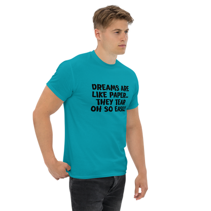 "Dreams are like paper, they tear oh so easily" printed on a tropical blue unisex classic tee worn by a male