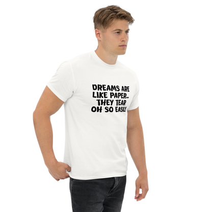 "Dreams are like paper, they tear oh so easily" printed on a white unisex classic tee worn by a male