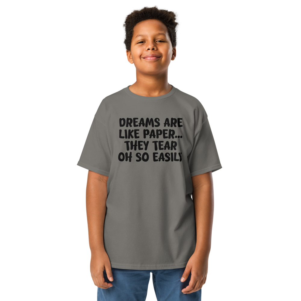 "Dreams are like paper, they tear oh so easily" printed on a charcoal youth classic tee worn by a male