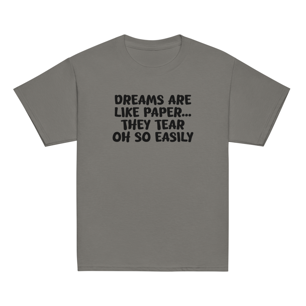 "Dreams are like paper, they tear oh so easily" printed on a charcoal youth classic tee laying on a flat surface