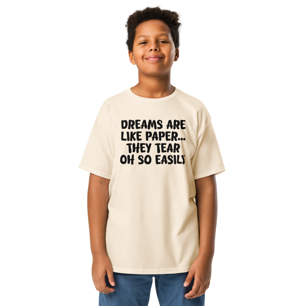 "Dreams are like paper, they tear oh so easily" printed on a natural youth classic tee worn by a male
