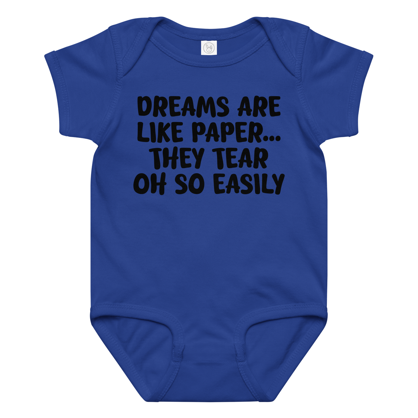 "Dreams are like paper, they tear oh so easily" printed on a royal baby jersey bodysuit laying on a flat surface amongst other clothes