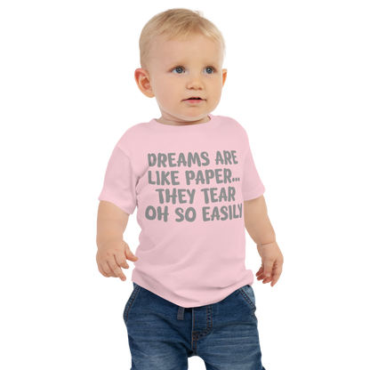 "Dreams are like paper, they tear oh so easily" printed on a pink baby jersey short sleeve tee worn by a male