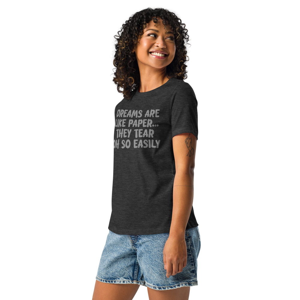 "Dreams are like paper, they tear oh so easily" printed on a dark grey heather women's relaxed t-shirt worn by a female