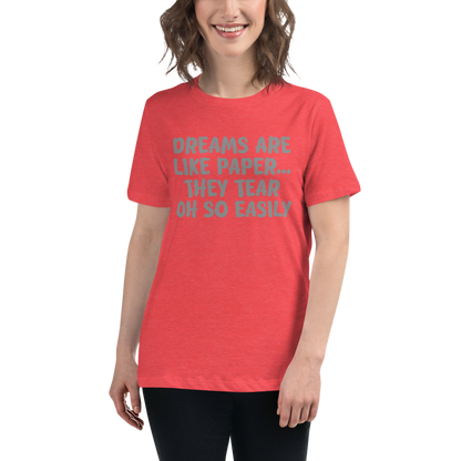 "Dreams are like paper, they tear oh so easily" printed on a heather red women's relaxed t-shirt worn by a female