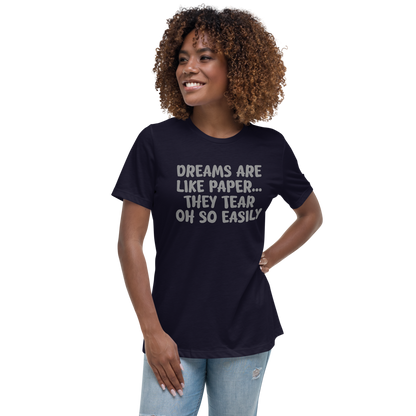 "Dreams are like paper, they tear oh so easily" printed on a navy women's relaxed t-shirt worn by a female