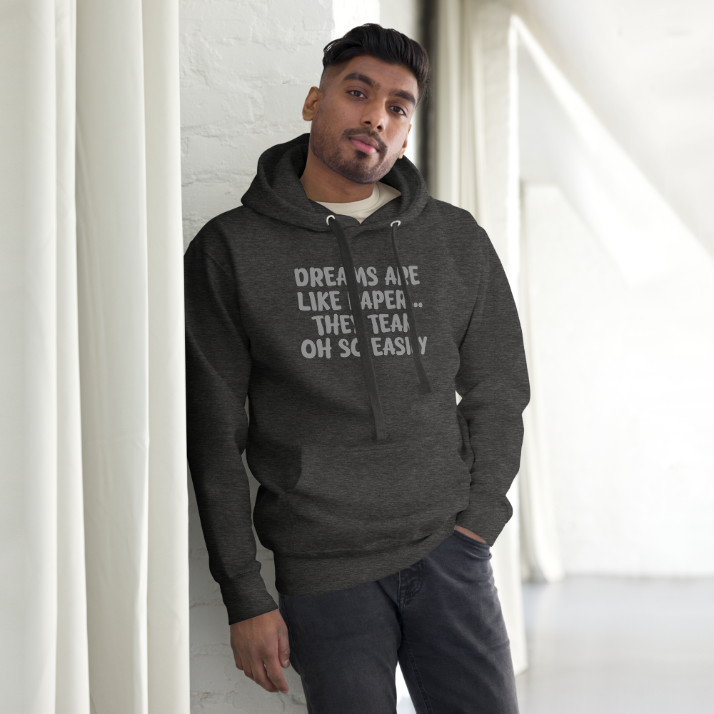 "Dreams are like paper, they tear oh so easily" printed on a charcoal heather unisex hoodie worn by a male
