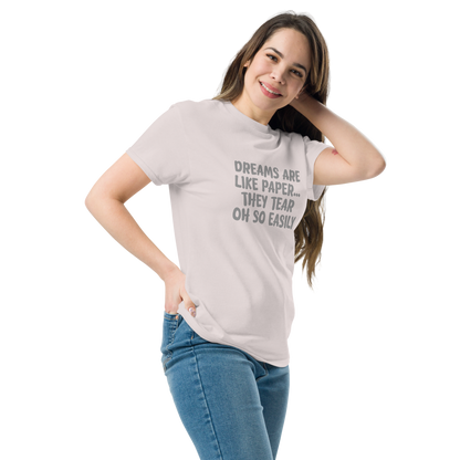 "Dreams are like paper, they tear oh so easily" printed on a ice grey unisex classic tee worn by a female