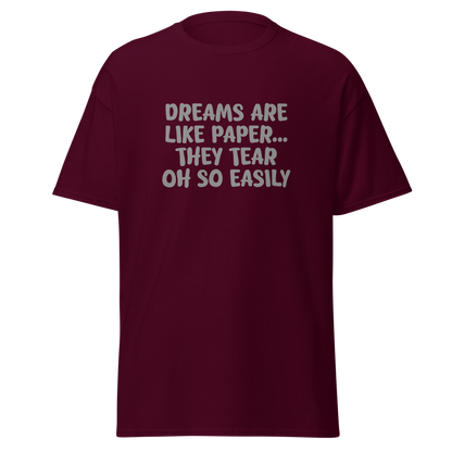 "Dreams are like paper, they tear oh so easily" printed on a maroon on an invisible body