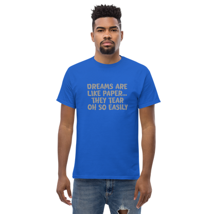 "Dreams are like paper, they tear oh so easily" printed on a royal unisex classic tee worn by a male