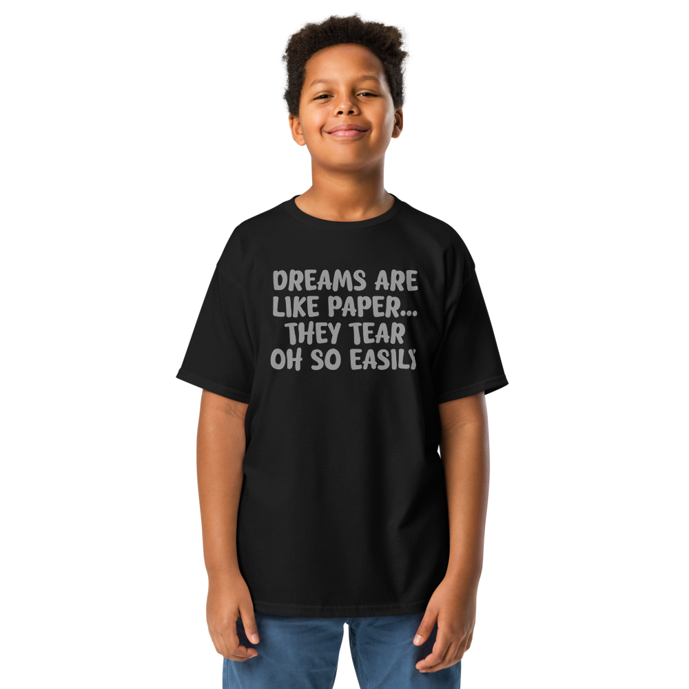"Dreams are like paper, they tear oh so easily" printed on a black youth classic tee worn by a male