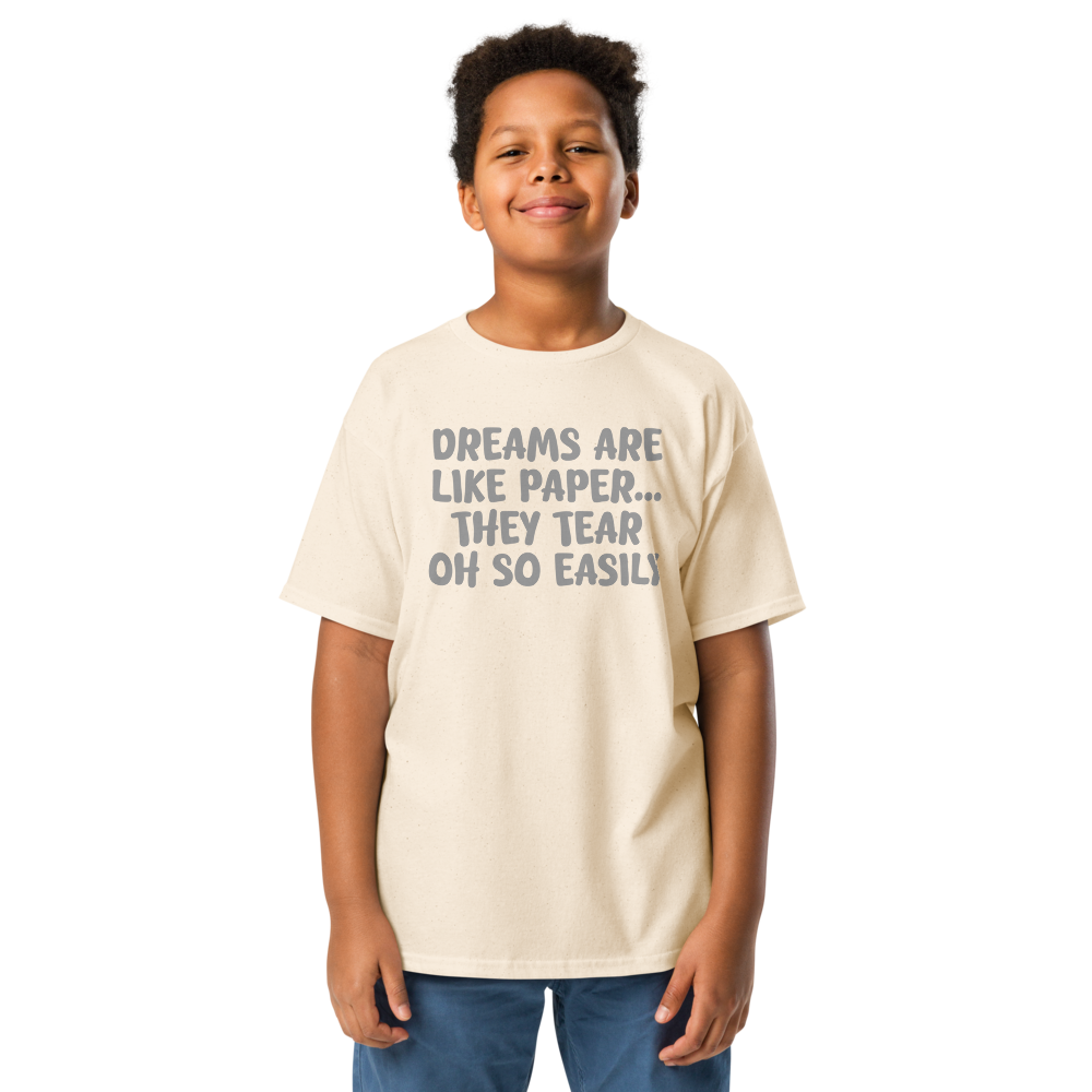"Dreams are like paper, they tear oh so easily" printed on a natural youth classic tee worn by a male